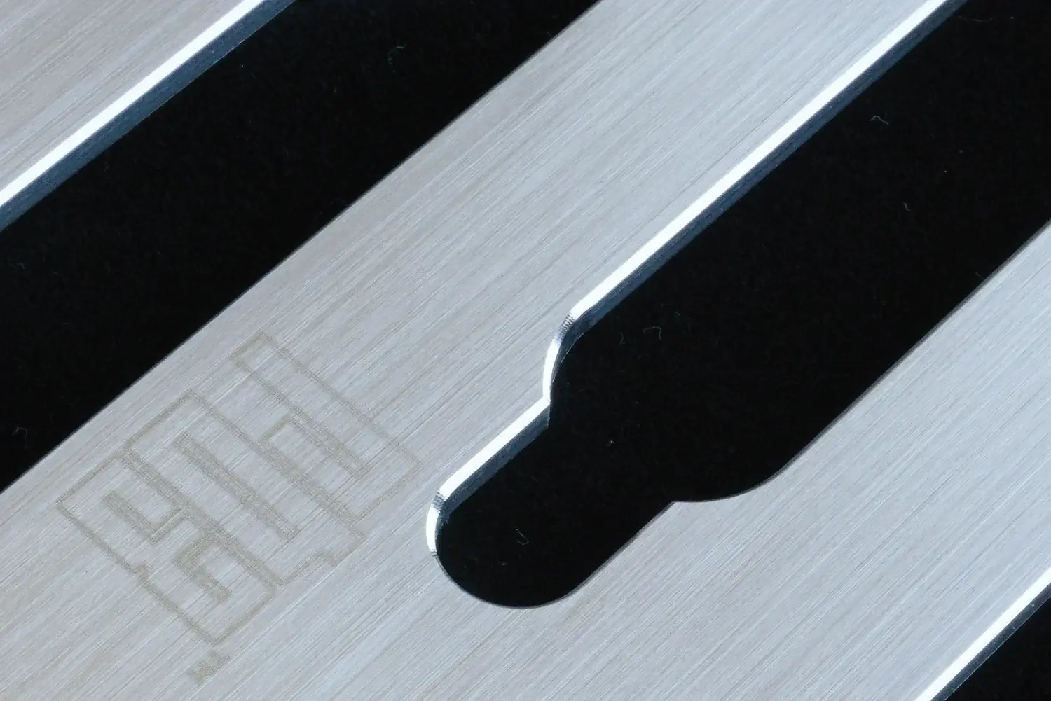 Close-up of the Redblock SCS-B corner shower shelf showing its brushed 316L stainless steel finish and CNC-rounded corners