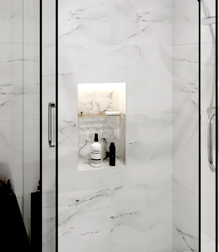 Recessed tiled shower niche installed in a large-format marble-look tile shower