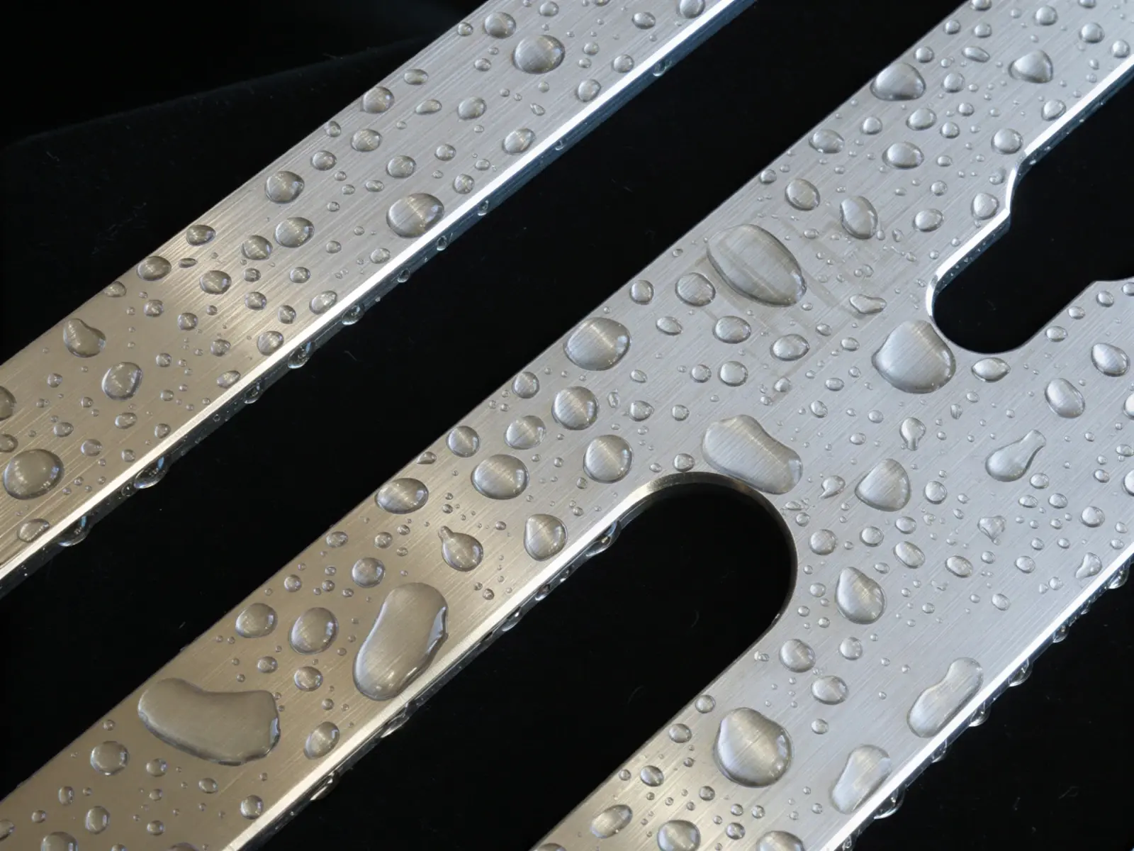 Close-up of the SCS-B corner shower shelf showing its brushed 316L stainless steel finish and CNC-rounded corners