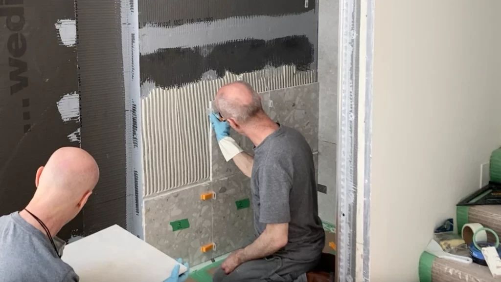 Placing leveling clip on wall tile -Lay shower tile post
