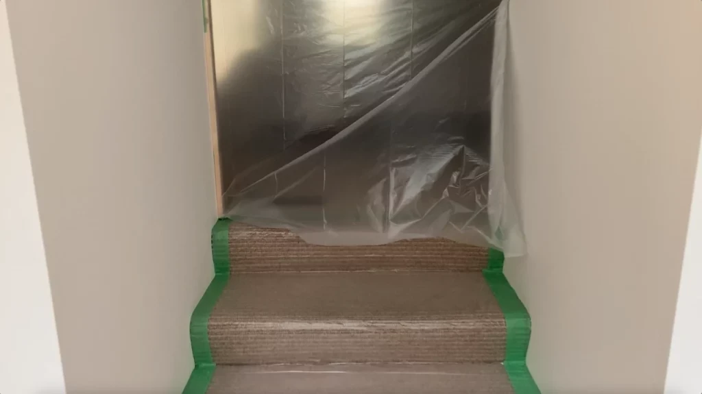 Plastic sheet in door opening - negative air pressure - removing tile from a bathroom wall post