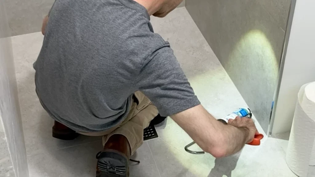 Caulking shower floor-to-wall margin -Lay shower tile post