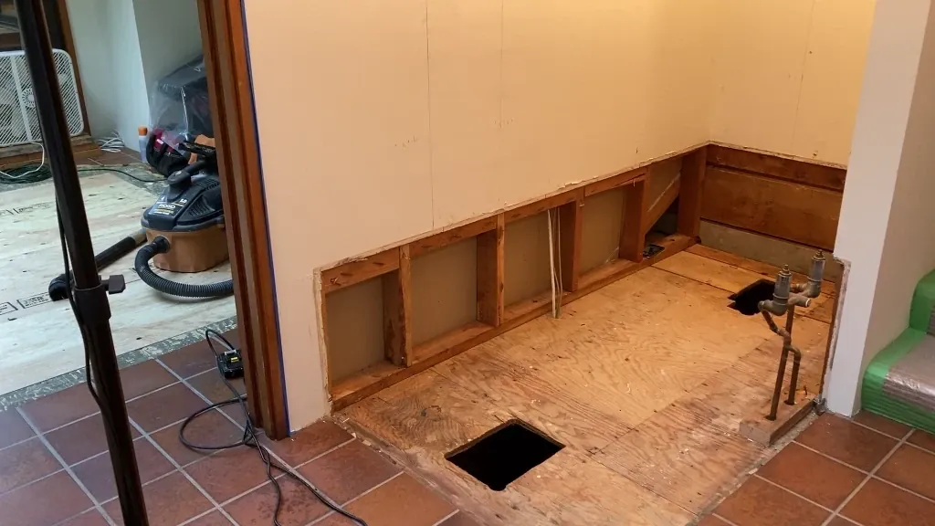 shower space cleared of old tub and debris - bathtub conversion to shower post