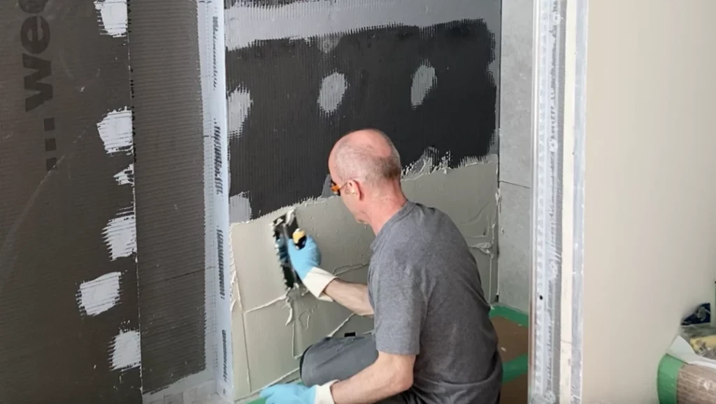 Spreading thinset on wall -Lay shower tile post