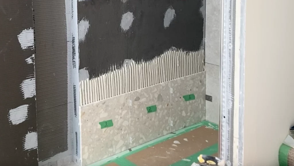 First row with shims and numbered -Lay shower tile post