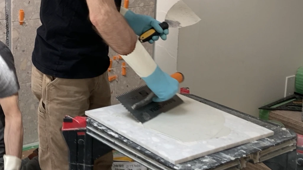 back buttering large format shower wall tile