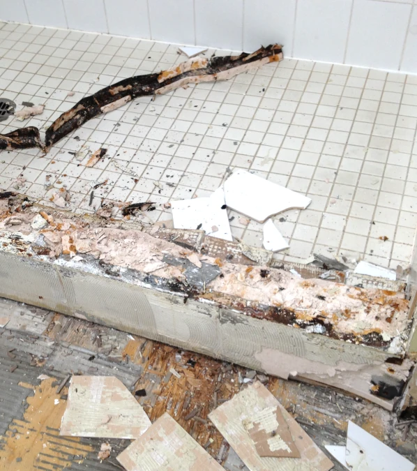 shower curb drywall deterioration from water exposure and lack of waterproofing