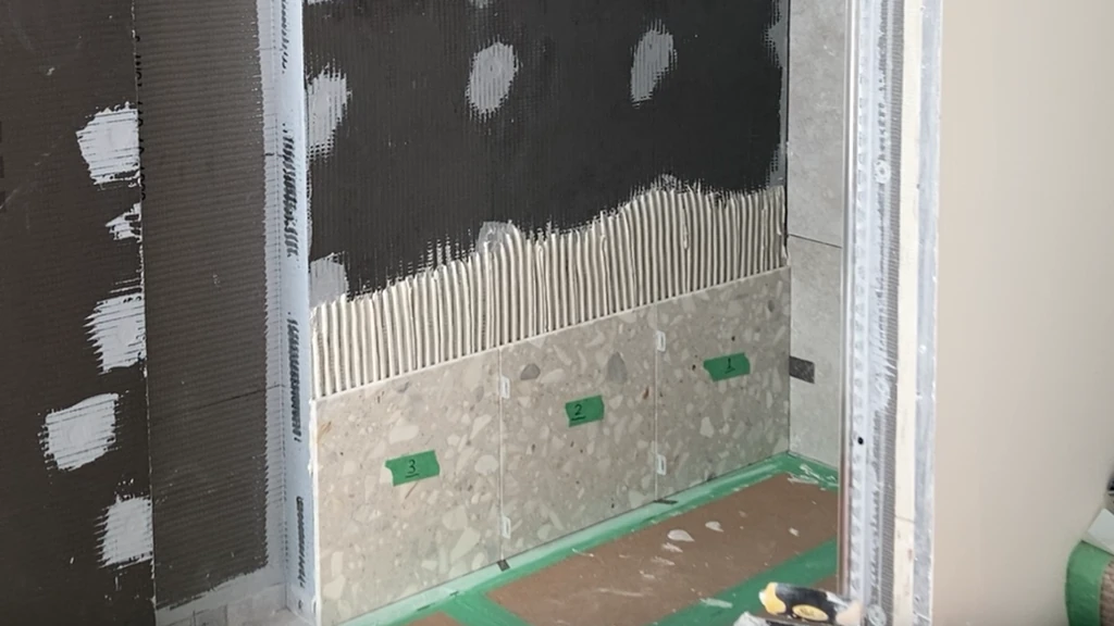 Installing shims under first row of wall tile ensures a level installation