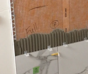 Installing porcelain tile against tile edge trim - best tile for shower walls post