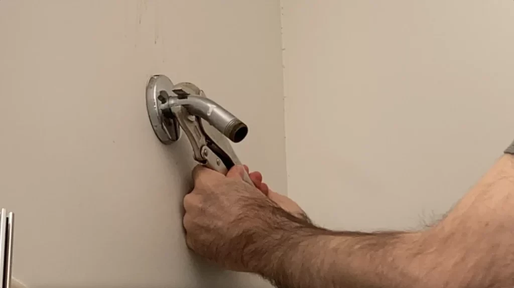 Shower head arm removal - removing tile from a bathroom wall post