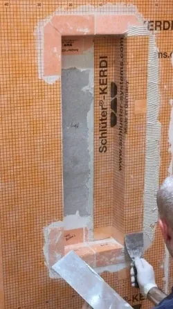 A bathroom remodel contractor waterproofing a custom-made shower niche - shower niche problems post