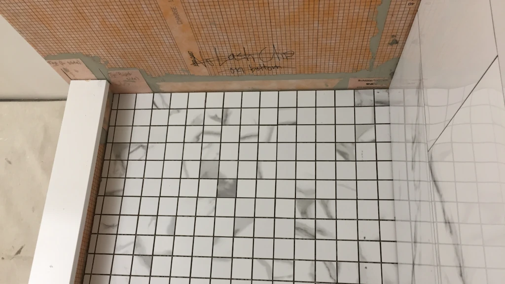 Laying shower pan tile before wall tile