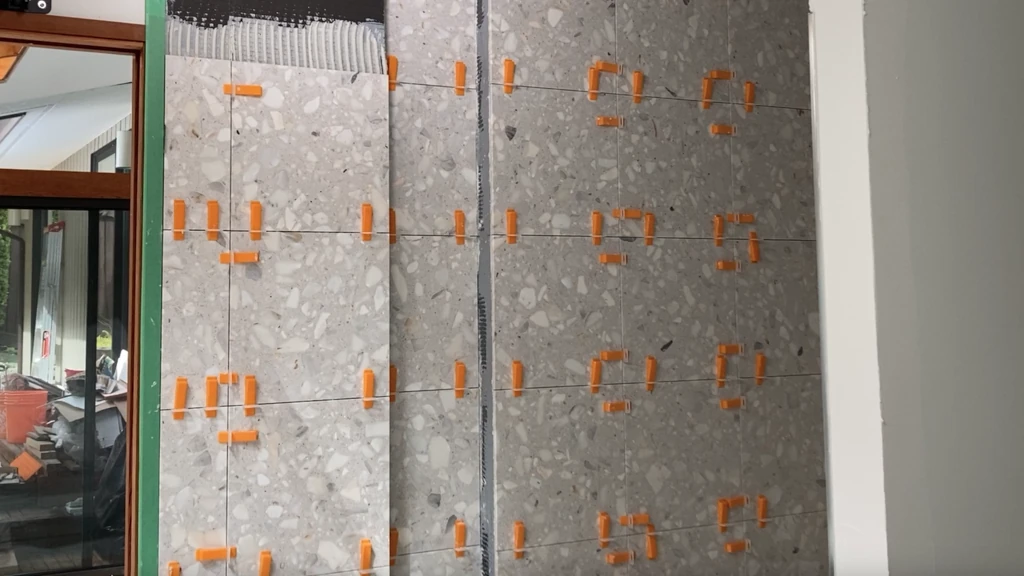 Installing leveling clips with marble tile on shower wall