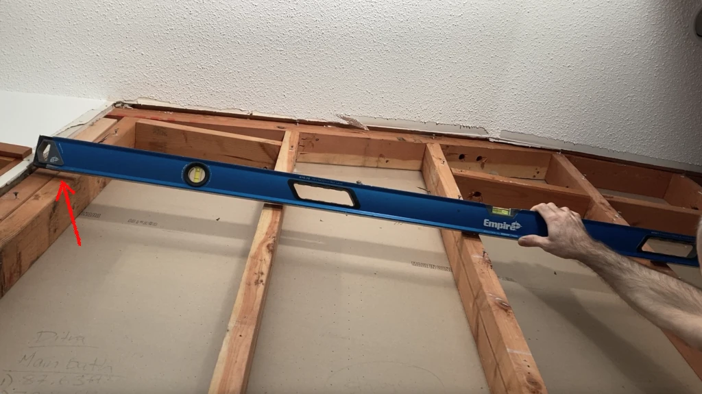 Assessing flatness of stud plane with straight edge