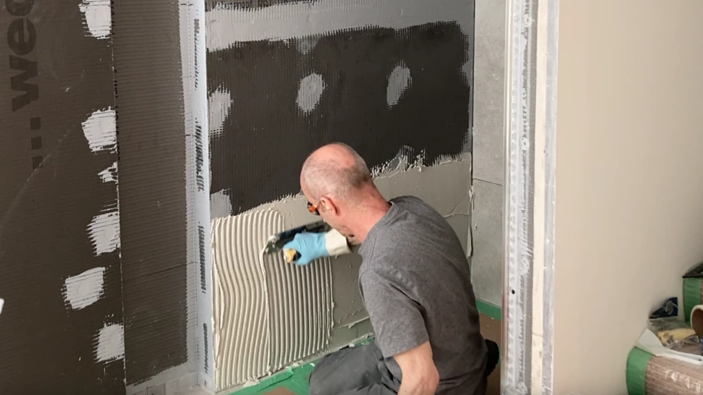 keying wet thinset with half-inch notched trowel
