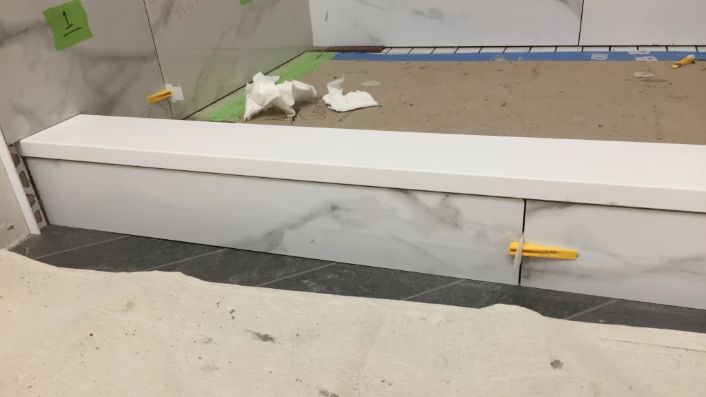 Tiled shower curb with Caesarstone cap