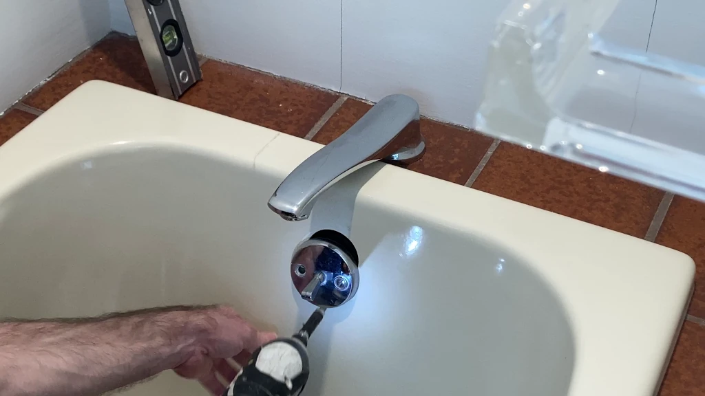 Removal of old bathtub overflow during demolition