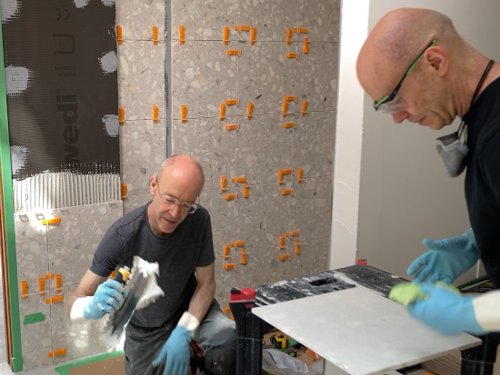 Dave & Steve tiling a shower wall