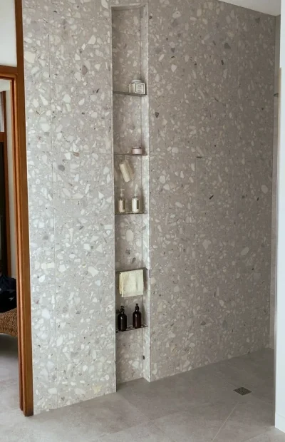 Floor to ceiling custom shower niche with SS shelves