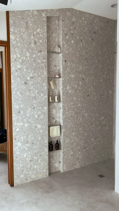 Floor to ceiling custom shower niche with SS shelves